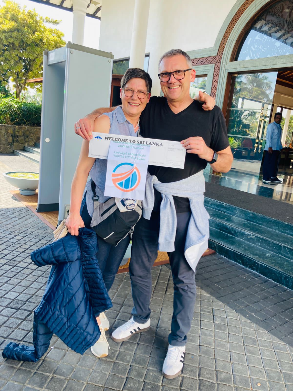 Couple with AKMT Holidays welcome board at hotel arrival