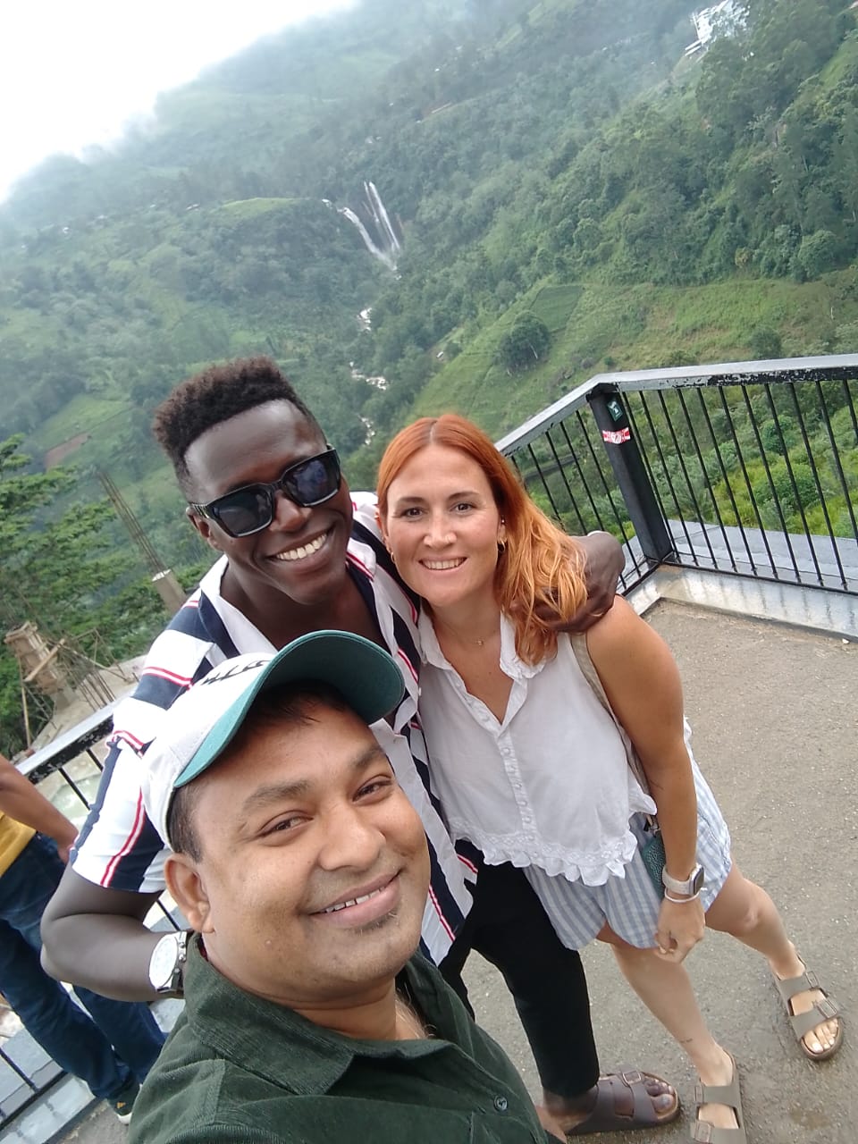 Guests at a misty hill country waterfall viewpoint