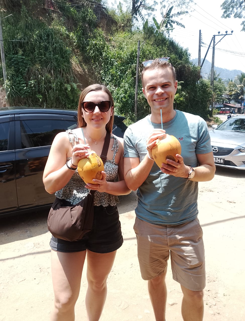 Couple enjoying fresh king coconut roadside